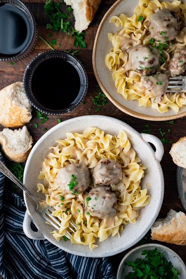 Overhead shot of two bowls of Swedish meatballs with egg noodles