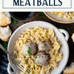 Overhead shot of fork in a bowl of Swedish meatballs with text title box at top