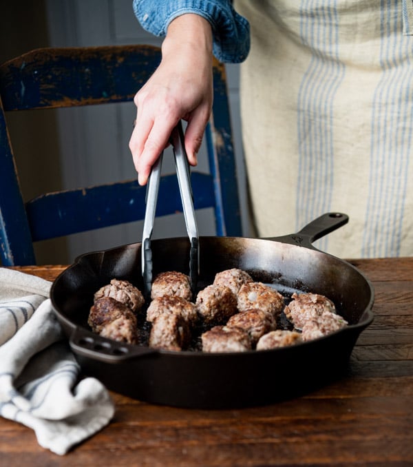 Frying Swedish meatballs in a cast iron skillet