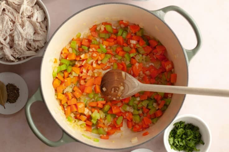 Adding the garlic and stirring it into the vegetables.