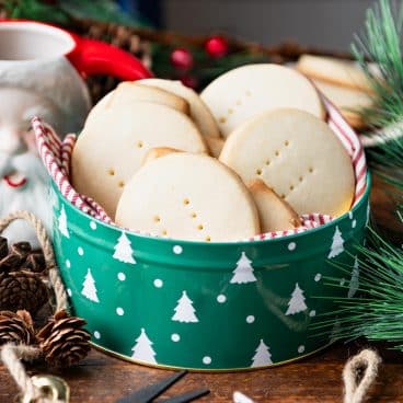 Square side shot of the best Scottish shortbread recipe in a green holiday cookie tin.
