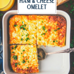 Overhead shot of a baking dish full of ham and cheese omelette with text title overlay