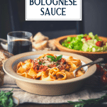 Side shot of a bowl of beef Bolognese with text title overlay
