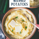 Overhead shot of a bowl of buttermilk mashed potatoes with butter and herbs on top with text title overlay.