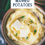 Close overhead shot of a bowl of creamy mashed potatoes with text title overlay.