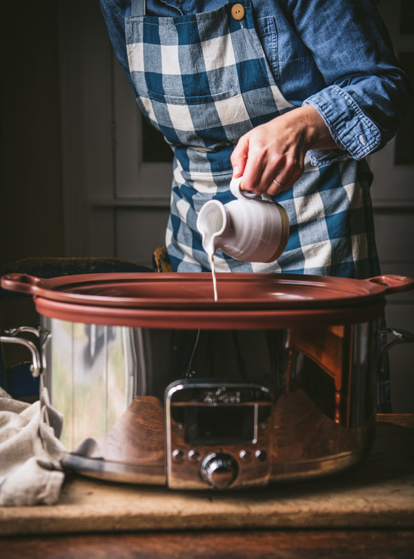 Pouring cream into a slow cooker