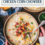 Overhead shot of hands holding a bowl of crock pot chicken corn chowder with text title box at top