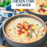 Close up side shot of a bowl of chicken and corn chowder with text title overlay