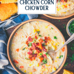 Overhead shot of a spoon in a bowl of chicken corn chowder with text title overlay