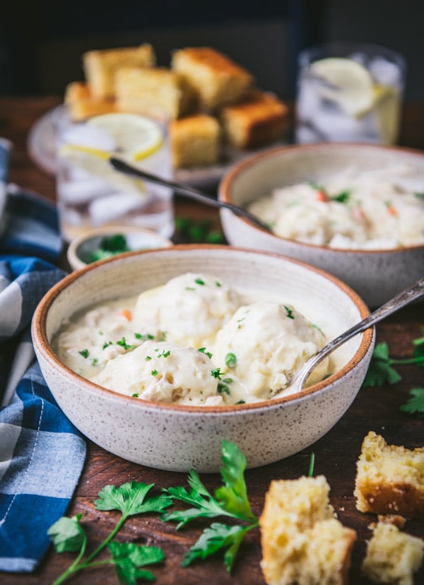 A bowl of chicken and dumplings, made with bisquick dumplings cooked in a creamy gravy and served with cornbread.