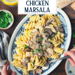 Overhead shot of hands eating an easy chicken marsala recipe with text title overlay