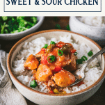 Close up side shot of a bowl of Chinese sweet and sour chicken with text title box at top