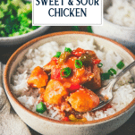 Side shot of baked sweet and sour chicken with text title overlay