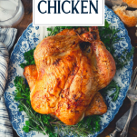 Overhead shot of roast chicken on a platter with text title overlay