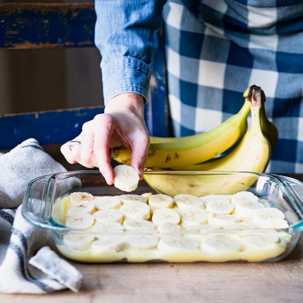 Arranging bananas in a glass dish.