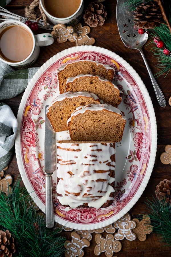 Overhead shot of gingerbread loaf sliced on a red and white serving platter