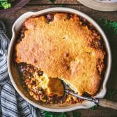Square overhead shot of a ground beef casserole with cornbread crust.