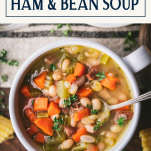 Close overhead image of a bowl of ham and bean soup with text title box at top.