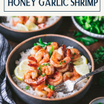 Two bowls of honey garlic shrimp on a wooden dinner table with text title box at top.