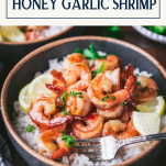 Close up side shot of honey garlic shrimp in a bowl with text title box at top