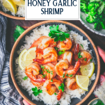Overhead shot of hands holding a bowl of honey garlic shrimp with rice and broccoli and text title overlay