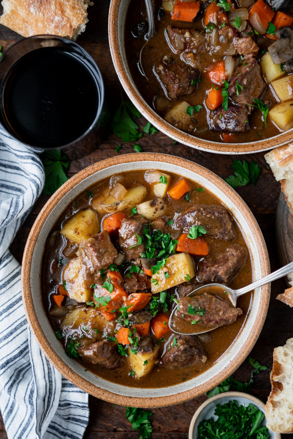 Overhead shot of a bowl of Irish stew with a side of bread