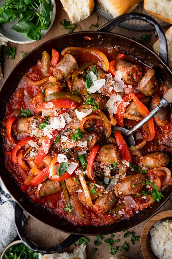 Close overhead image of a skillet full of Italian sausage and peppers