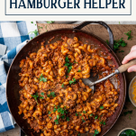 Overhead shot of a skillet of homemade hamburger helper with text title box at top.