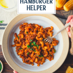 Hands eating a bowl of hamburger helper with text title overlay.