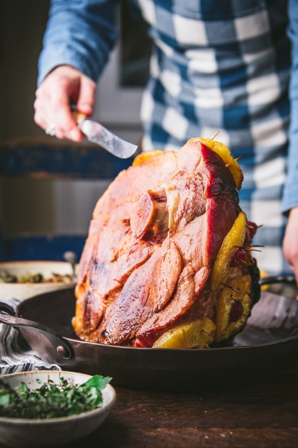 Carving a pineapple glazed ham.