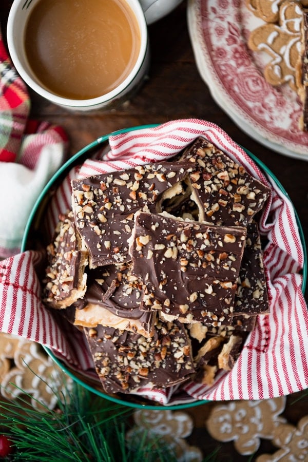 Close overhead shot of a tin of chocolate saltine toffee on a table