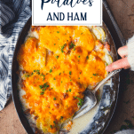 Hands serving scalloped potatoes and ham with text title overlay