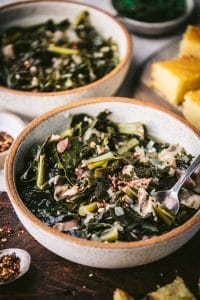 Side shot of Southern collard greens recipe served with cornbread