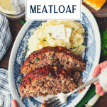 Hands eating Southern meatloaf on a plate with text title overlay