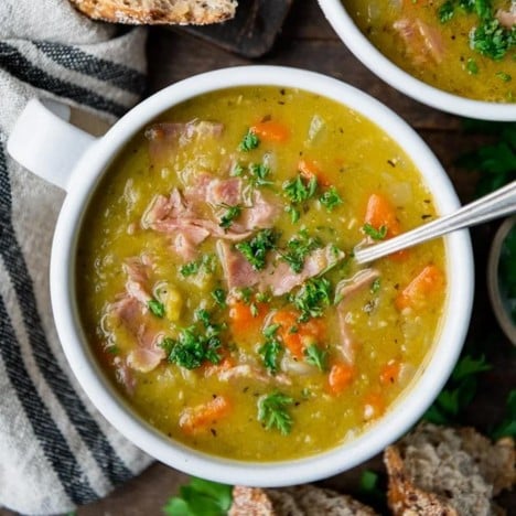 Square overhead shot of a bowl of split pea soup with ham