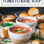 Side shot of two bowls of easy tomato basil soup recipe with text title box at top.