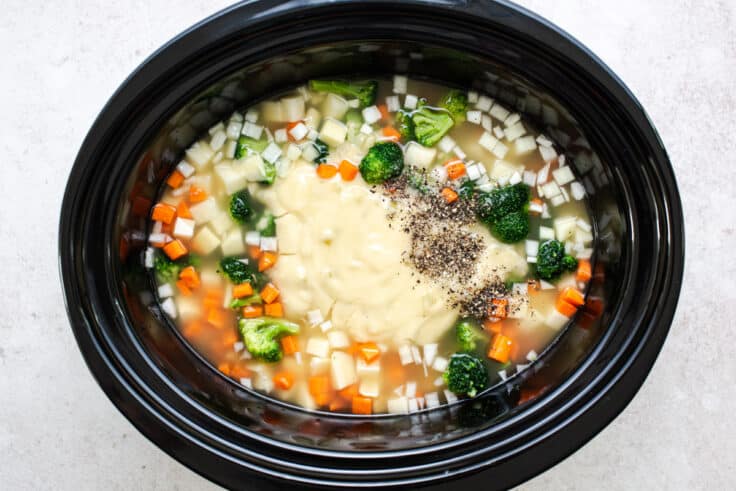 Ingredients for crockpot broccoli cheese soup in a slow cooker before cooking.