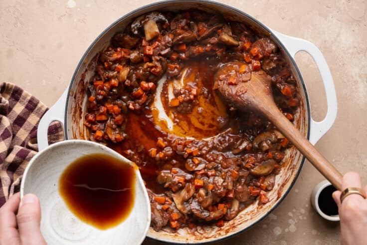Adding beef broth to make the gravy.
