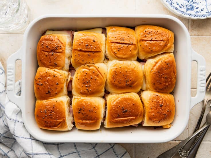 Horizontal overhead shot of baked ham and cheese sliders.