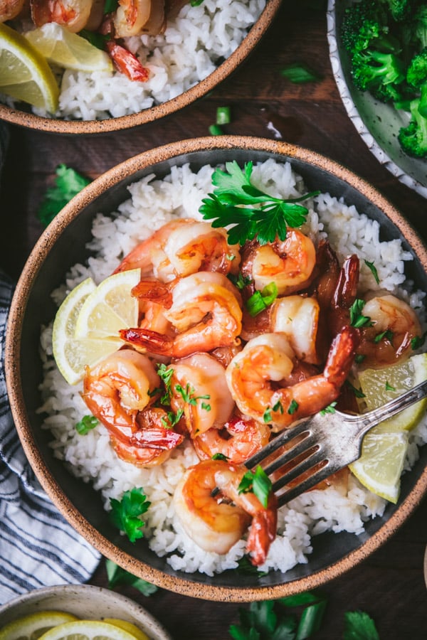 Close overhead image of honey garlic shrimp with rice in a bowl.