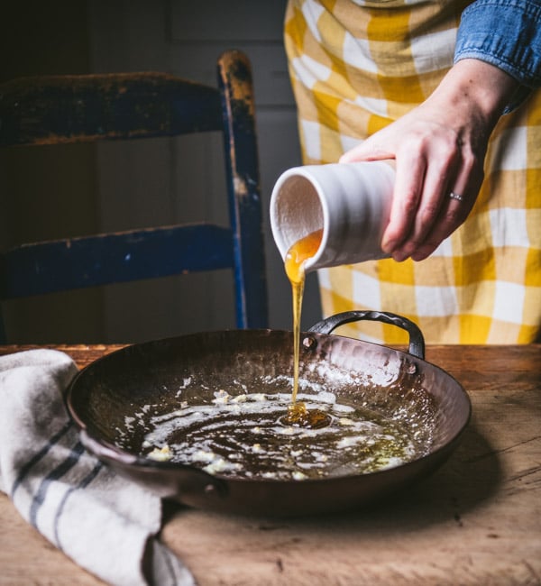Pouring honey into a skillet