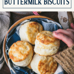 Overhead shot of hand picking up the best 3 ingredient biscuit recipe with text title box at top