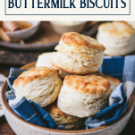 Side shot of a basket of buttermilk biscuits with text title box at top
