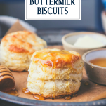 Side shot of 3 ingredient buttermilk biscuits with honey on a tray with text title overlay