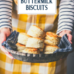 Hands holding a tray of the best 3 ingredient biscuit recipe with text title overlay
