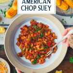 Fork in a bowl of American chop suey with text title overlay
