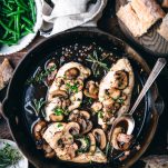 Overhead shot of balsamic chicken with mushrooms in a cast iron skillet.