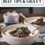 Side shot of two bowls of beef tips and gravy with text title box at top.