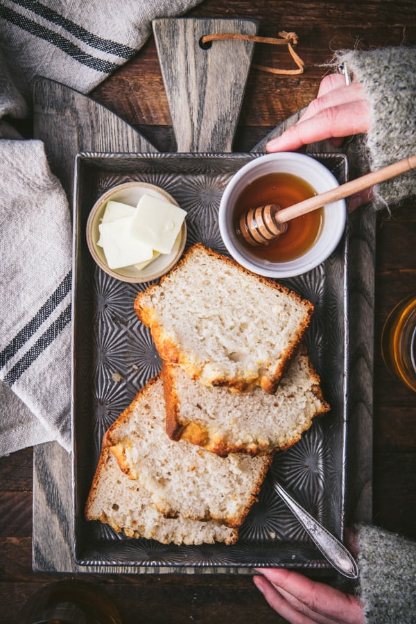Overhead shot of hands holding a pan of easy beer bread recipe
