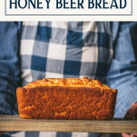 Hands holding beer bread on a platter with text title box at top